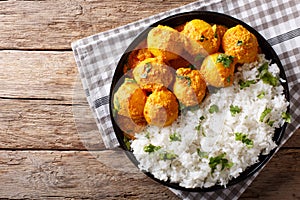 Delicious homemade Kashmiri Dum aloo potatoes with rice close-up. horizontal top view