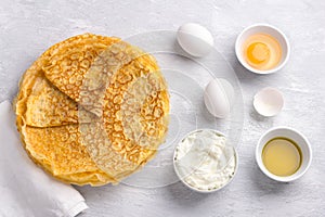 Delicious homemade Low Carb Diet Keto Pancakes without flour and nuts with ingredients for cooking on gray textured background