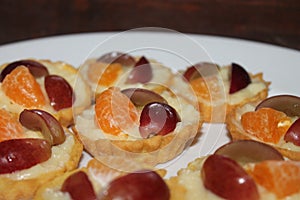 Delicious homemade mini fruit pies with orange slice and grape slices