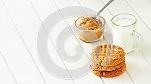 Delicious homemade peanut butter cookies with mug of milk. Healthy snack or tasty breakfast concept. Banner size.