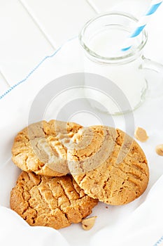 Delicious homemade peanut butter cookies with mug of milk. White photo