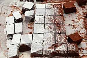 Delicious homemade raw chocolates cut into square shapes sprinkled with powdered sugar. Valentines Day celebration