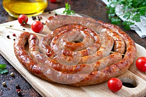 Delicious homemade sausages, baked  rings on skewers, with cherry tomatoes. Oktoberfest snack. Summer picnic dish