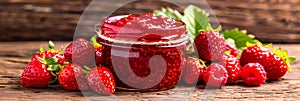 Delicious homemade strawberry jam stored in a glass jar made from fresh strawberries