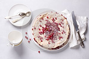 Delicious homemade tart with red currants and meringue, decorated with fresh berries, sprinkled with powdered sugar