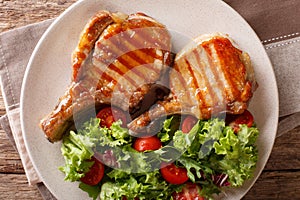 Delicious honey grilled chop pork served with a salad of fresh v