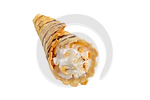 Delicious honeyed waffles, twisted into cones with cream, nuts, chocolate topping isolated on white background