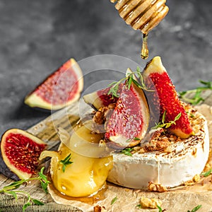 Delicious hot baked camembert with figs, nuts and honey, Restaurant menu, dieting, cookbook recipe top view