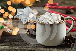 Delicious hot chocolate with marshmallows and Christmas decor on wooden table, closeup. Space for text