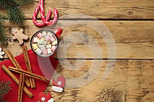 Delicious hot chocolate with marshmallows and gingerbread cookies on wooden table, flat lay. Space for text