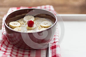 Delicious hot oatmeal with fruit and berries on wooden background, healthy Breakfast