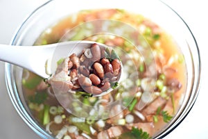 Delicious hot and spicy pork meat along with red beans in the soup photo