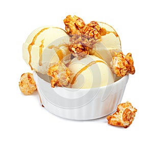 Delicious ice cream with caramel popcorn and sauce in dessert bowl