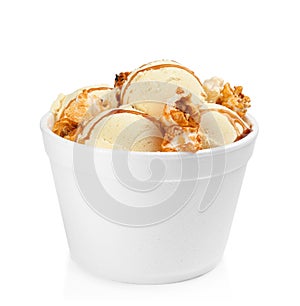 Delicious ice cream with caramel popcorn and sauce in dessert bowl