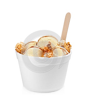 Delicious ice cream with caramel popcorn and sauce in dessert bowl