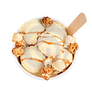 Delicious ice cream with caramel popcorn and sauce in dessert bowl on white background