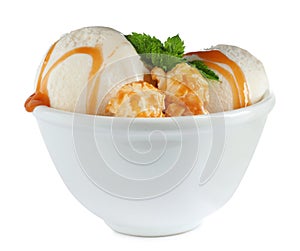 Delicious ice cream with caramel sauce, mint and popcorn in bowl