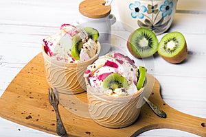 Delicious ice cream in a cup with tasty fruits