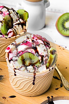 Delicious ice cream in a cup with tasty fruits