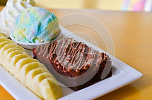 Delicious ice rainbow, brownie, cake, vanilla cream and banana in holiday.