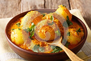 Delicious Indian Potato Dum aloo in curry sauce close-up. horizontal