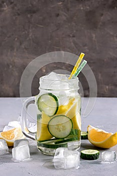 Delicious infused water with cucumber, lemon in glass bottle for fat flush detox.