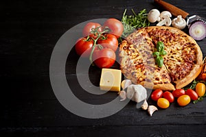 Delicious italian pizza served on black wooden table