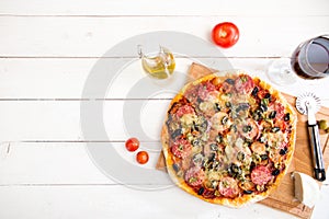 Delicious italian pizza served on white wooden table. Top view