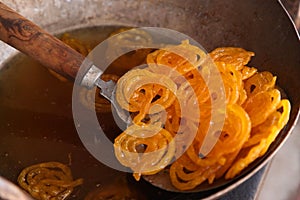 Delicious jalebi frying in oil pan