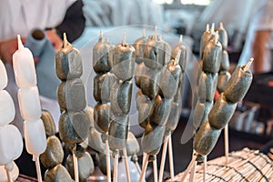 Delicious Japanese mochi balls on a stick in the streets in Hiroshima Japan