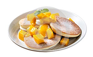 Delicious Japanese souffle pancake with dice mango and jam on white table background