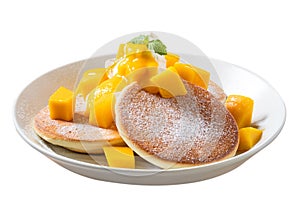 Delicious Japanese souffle pancake with dice mango and jam on white table background