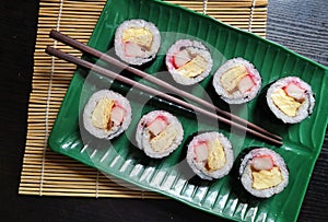 Delicious Japanese Sushi on green plate