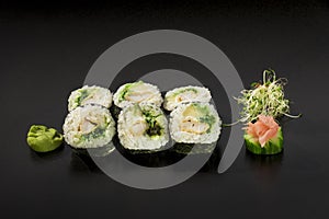 Delicious Japanese sushi rolls decorated with seaweed salad and