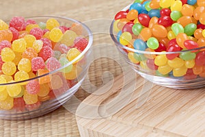Delicious jelly beans and fruit gum drops in glass bowls