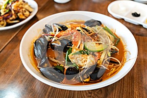 Delicious jjamppong, jjambbong, Chinese-style Korean noodle soup topped with spicy seafood and kimchi broth in South Korea