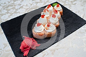 Delicious, juicy and appetizing Philadelphia rolls deluxe with red caviar.