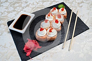 Delicious, juicy and appetizing Philadelphia rolls deluxe with red caviar.