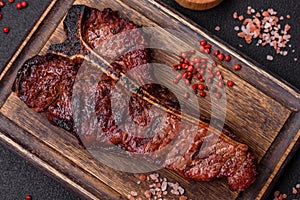 Delicious juicy beef tbone steak with salt, spices and herbs