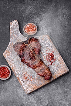 Delicious juicy beef tbone steak with salt, spices and herbs