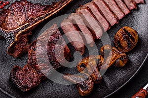 Delicious juicy beef tbone steak with salt, spices and herbs photo
