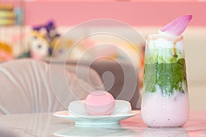 Delicious juicy fresh milk green tea on glass table Blurred leaf reflection background