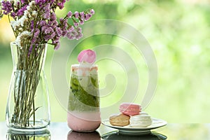 Delicious juicy fresh milk green tea on glass table Blurred leaf reflection background