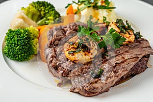 Delicious juicy grilled steak and shrimp with grilled broccoli and cauliflower.  Surf and Turf style