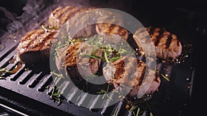 Delicious juicy meat steak cooking on grill. Prime beef fry on electric roaster, rosemary, black pepper, salt. Slow