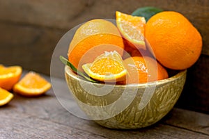 Delicious and juicy orange, organic oranges in bowl on table