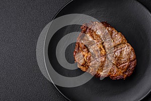 Delicious juicy pork or beef steak grilled with salt, spices and herbs