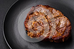 Delicious juicy pork or beef steak grilled with salt, spices and herbs