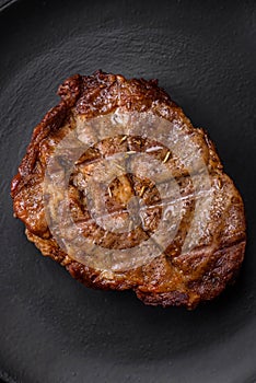 Delicious juicy pork or beef steak grilled with salt, spices and herbs