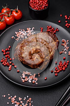 Delicious juicy pork or beef steak grilled with salt, spices and herbs